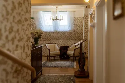 a hallway with chairs and a table and a window at Allegro Hotel in Ljubljana