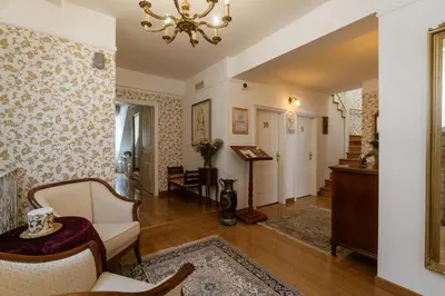 a living room filled with furniture and a chandelier at Allegro Hotel in Ljubljana