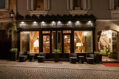 a store front of a hotel with stools in front at Allegro Hotel in Ljubljana