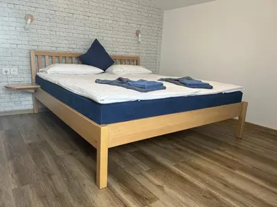 a bed with blue towels on it in a room at Pension TTT in Bled