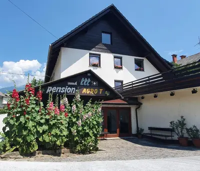 a building with a sign on the front of it at Pension TTT in Bled