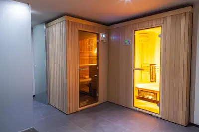 a room with a closet with glass doors at Hotel Pokljuka in Goreljek