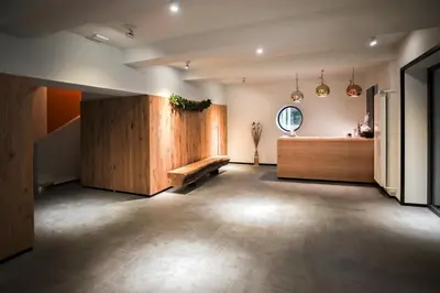 a large room with a bench in the middle of it at Hotel Pokljuka in Goreljek