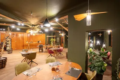 a dining room with tables and chairs and a room with tables and chairsktop at Hotel Boka in Bovec