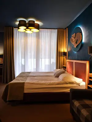 a bedroom with a large bed and a window at Hotel Boka in Bovec