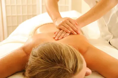 a woman getting a massage from a therapist at Hotel Bajt Maribor in Maribor