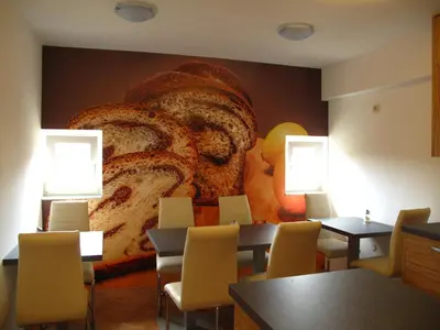 a dining room with a large bread mural on the wall at B&B By The Way in Ljubljana