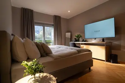 a living room with a couch and a flat screen tv at Hotel DRAŠ in Maribor