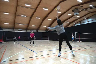 a woman hitting a tennis ball with a racket at Hotel DRAŠ in Maribor