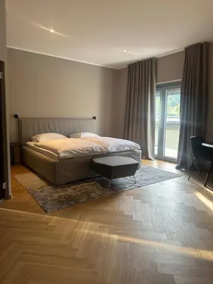 a bedroom with a bed and a table in it at Hotel DRAŠ in Maribor
