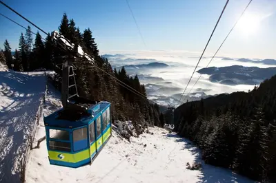 a ski lift going up a snow covered mountain at Wellness Hotel Montis in Mozirje
