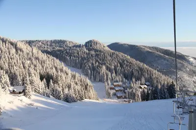 a snow covered mountain with a ski lift at Wellness Hotel Montis in Mozirje