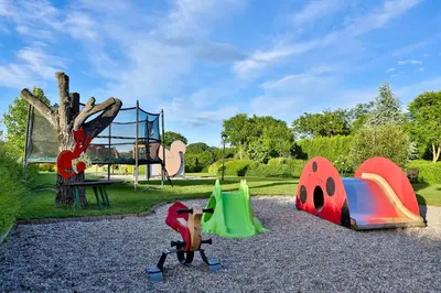 a playground with different types of play equipment in a park at Gostilna in motel Pri Lešniku in Maribor