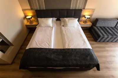 two beds in a room with two lamps at Gostilna in motel Pri Lešniku in Maribor