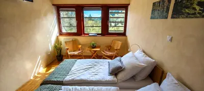 a bedroom with a bed and a table with chairs at Hotel Celjska Koca in Celje