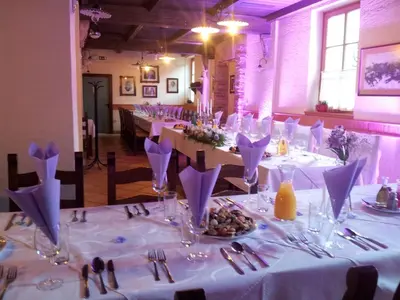 a dining room with a table with white table cloth at Hotel Kovac in Osilnica