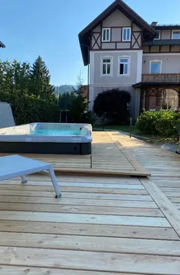 a pool on a deck in front of a house at Vila Alice Bled - Adults only in Bled