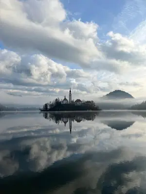 a church on an island in the middle of a lake at Vila Alice Bled - Adults only in Bled