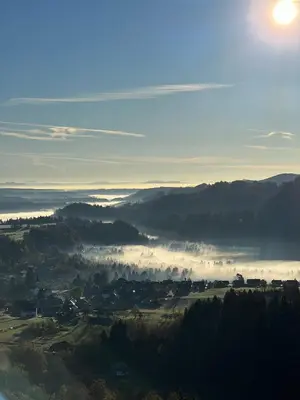 a view of a foggy valley with the sun in the sky at Vila Alice Bled - Adults only in Bled