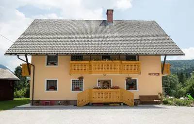 a house with a deck and a balcony at Apartmaji Matej Cvetek in Bohinj
