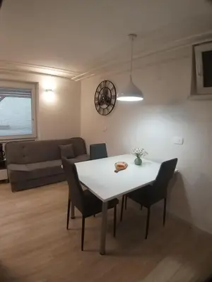 a living room with a white table and chairs at Apartmaji Taler in Bohinj