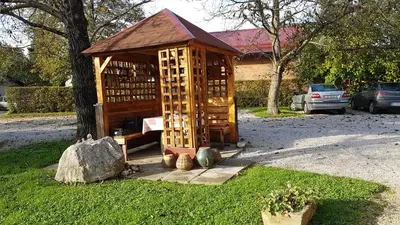 a small wooden building next to a tree at Apartments Vita Center in Rogaška Slatina