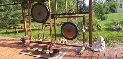 a wooden deck with a gazebo with bowls and statues at Apartments Vita Center in Rogaška Slatina