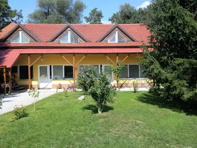 a house with a red roof and a yard at Apartments Vita Center in Rogaška Slatina