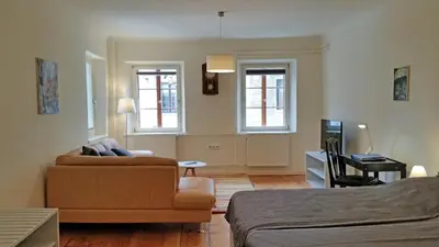a living room with a couch and a chair at Jager Apartments Tour As Ljubljana in Ljubljana