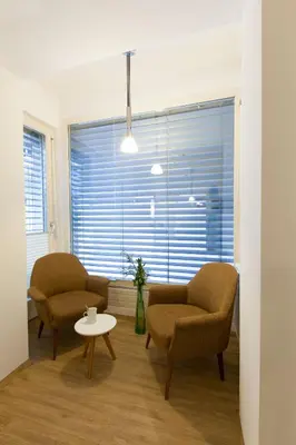a living room with two chairs and a table and a window at Jager Apartments Tour As Ljubljana in Ljubljana