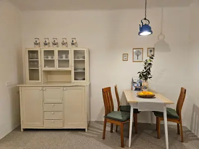 a kitchen with a table and a white cabinet at Jager Apartments Tour As Ljubljana in Ljubljana