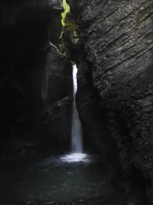 a waterfall in the middle of a cave at Apartment Honey Bee with SAUNA in Kobarid