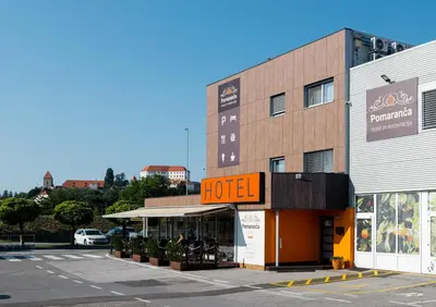 a hotel on the side of a street at Hotel Pomaranča in Ptuj