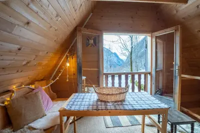 a room with a table in a cabin at Bezgova Hišica in Bovec