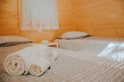 a room with two beds with towels on them at TOP rafting center in Bovec