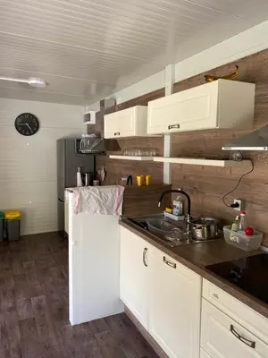 a kitchen with white cabinets and a sink at TOP rafting center in Bovec