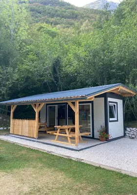 a small shed with a picnic table in it at TOP rafting center in Bovec