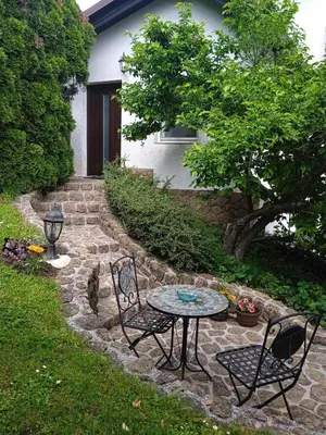 a patio with a table and chairs in a yard at Vila Weekend in Rogaška Slatina