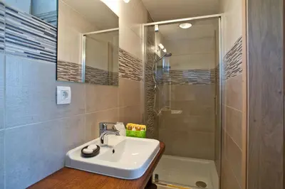 a bathroom with a sink and a shower at Apartment House Alp in Bled