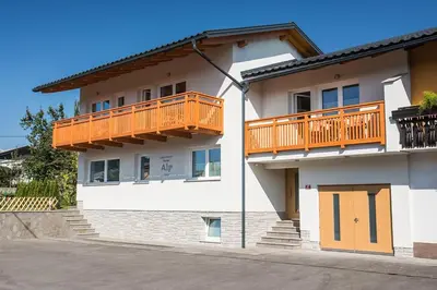 a white building with an orange balcony on it at Apartment House Alp in Bled