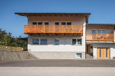 a large house with a deck on top of it at Apartment House Alp in Bled
