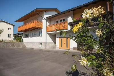 a building with balconies and flowers in front of it at Apartment House Alp in Bled