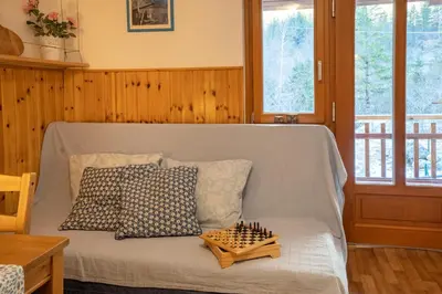 a bed with a chess board on top of it at Bovec Home At Three Samoyeds in Soča