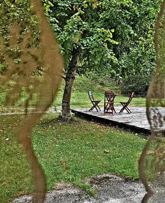 two benches sitting on a wooden boardwalk in a park at Bovec Home At Three Samoyeds in Soča