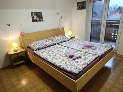 a bedroom with a bed with two towels on it at Apartmaji Verica Ceklin in Bohinj