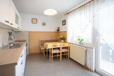 a kitchen with a table and a dining room at Apartmaji Colja in Bohinj
