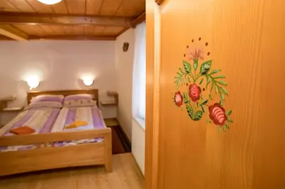 a bedroom with a bed with a painting on the wall at Turistična kmetija Gartner in Bohinj