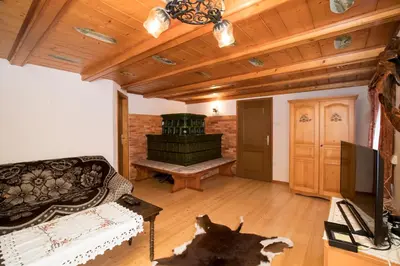 a living room with a couch and a television at Turistična kmetija Gartner in Bohinj