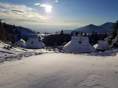 a group of snow covered huts in the snow at Chalet Resa - Velika planina in Stahovica