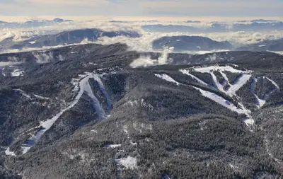 an aerial view of a mountain range with snow at Depandansa Brinje in Zreče